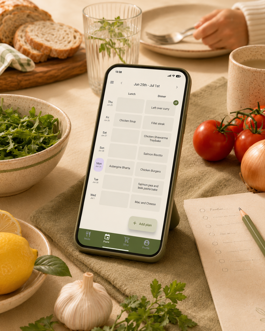A family table with the Rooted weekly meal plan open on a phone